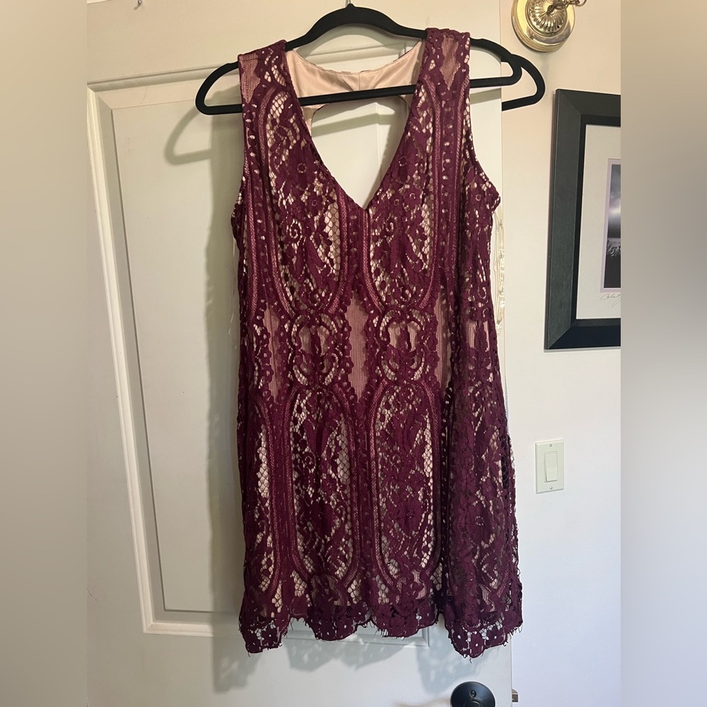 Lacy maroon colored dress worn one time. Can wear it casually or dress it up.